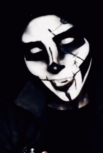 man wearing a black and white mask with fangs