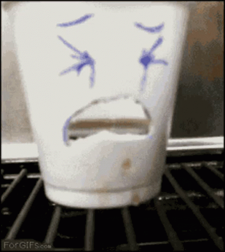 the face has drawn on the side of a ceramic cup