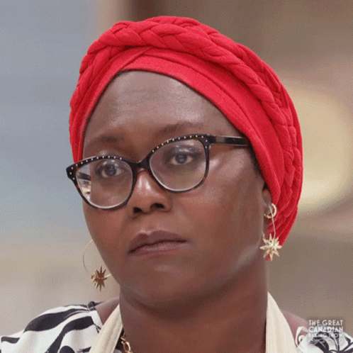 a woman is wearing glasses and a turban