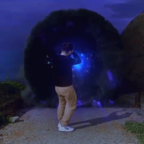 man standing inside a black tunnel like object