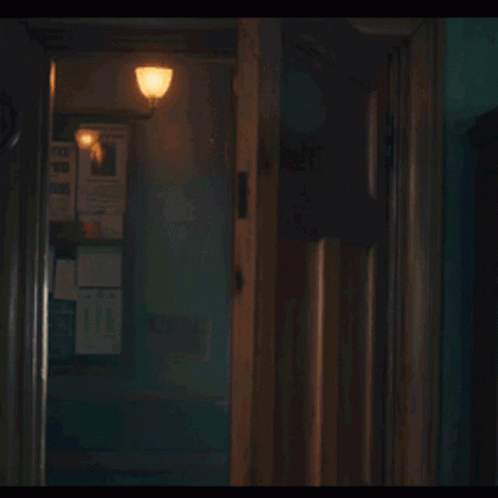 a creepy looking hallway with an open door and no one