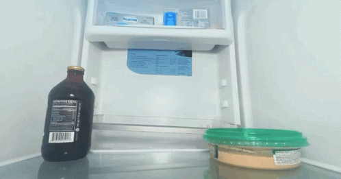a empty refrigerator next to a plastic container