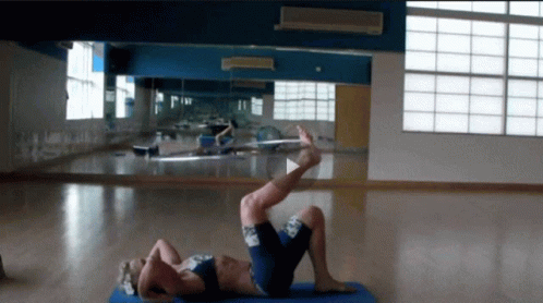 two people doing aerial moves inside a room