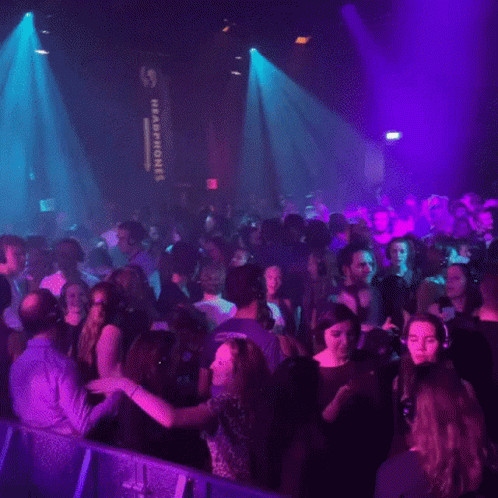 crowd in nightclub with purple and yellow lights