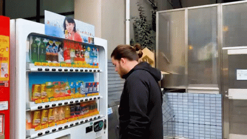 two people by vending machines in a japanese restaurant
