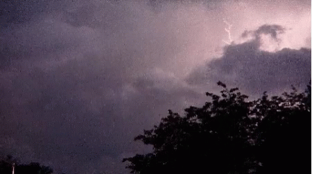 a lightning bolt hitting through a dark cloudy sky
