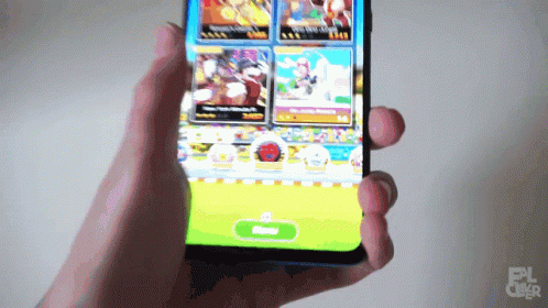 someone holding up a smart phone displaying game images