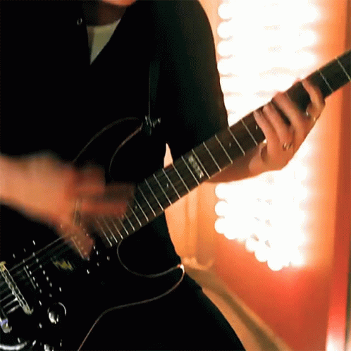 a man plays the guitar on the stage