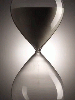an hourglass with a black sand running through it