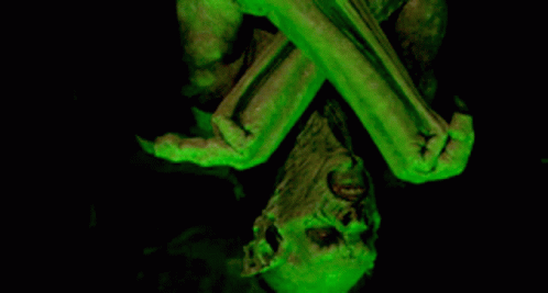 the head and arms of an old statue are glowing green