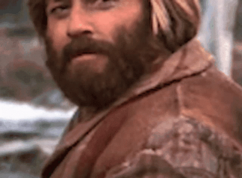 a man with a turban stares to the side