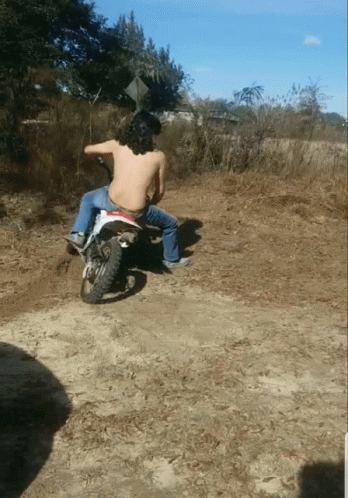 a man rides a dirt bike in the wild