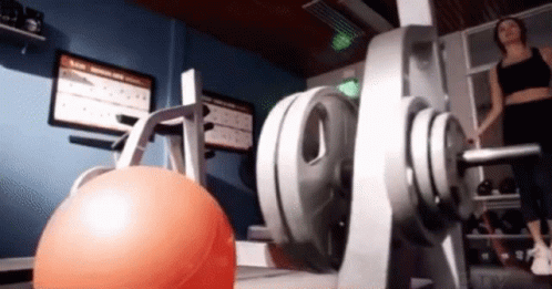an exercise center with stationary balls, dumb racks and electronic equipment