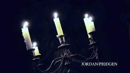 four candles are glowing in the dark