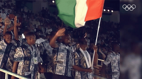 people wearing uniforms holding up an italian flag