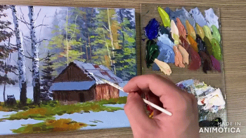 someone painting a cabin in the woods with paints