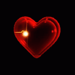 a blue heart shaped object is glowing on the dark