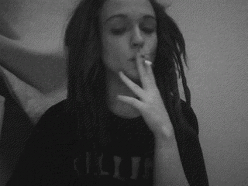a woman smoking while wearing an unisex tee