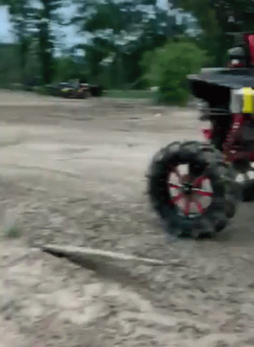an open wheel drive buggy on a dusty road