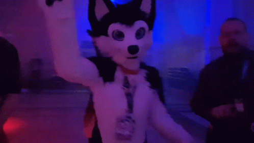 a man wearing a wolf costume and a purple light