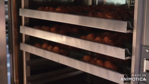 several tiered trays are stacked in a large commercial oven