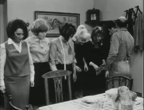 a black and white po of women in the kitchen
