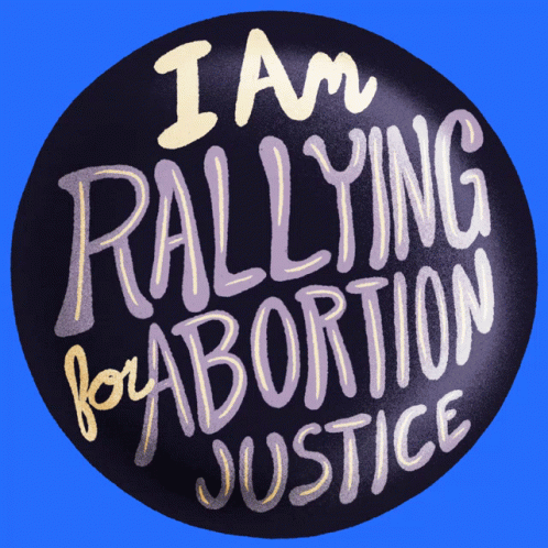 a badge that reads i am rallying for abortion justice