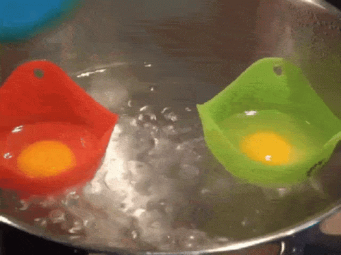 two plastic bowls are sitting inside of boiling water