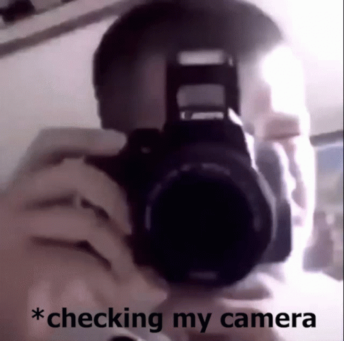a man holding a camera taking a picture