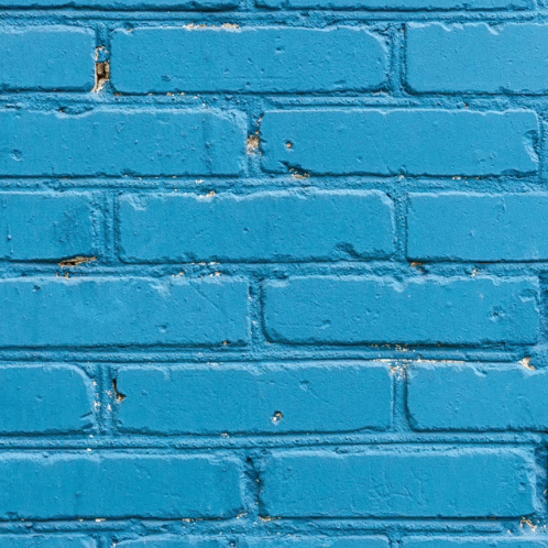a closeup po of a yellow brick wall