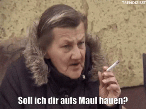 woman is smoking in a black coat and text that says, soli ich er afs maul hauer?