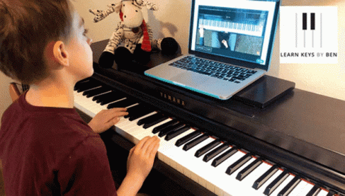 a boy plays on an electronic piano