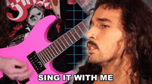 a man that has a pink guitar in his hand