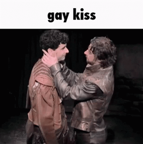 guy in leather jacket getting ready to kiss the guy in a white leather jacket