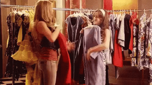 two women look at clothes in a clothing store