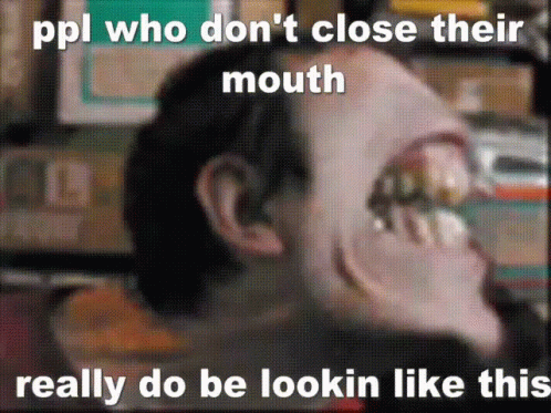 a guy has an open mouth with large teeth