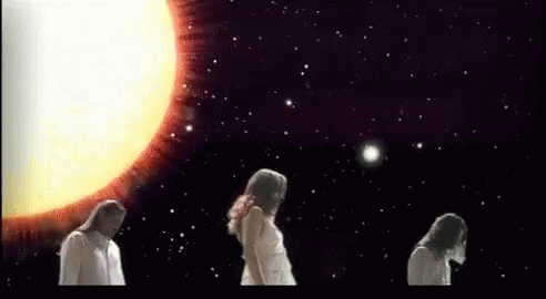 two women looking at a glowing object in the sky
