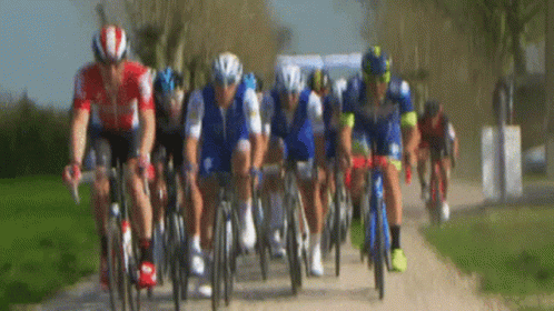 a blurry picture of several bicyclists riding bikes