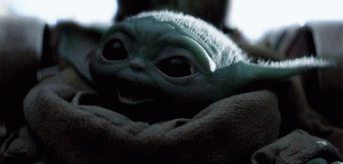 an image of a baby yoda with his eyes closed