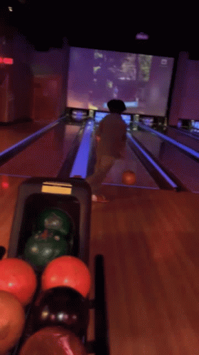 people play bowling at an amut attraction