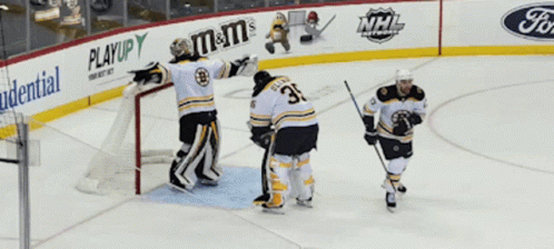 four young hockey players are congratulating each other in a goalie's moment