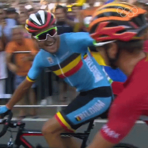 the two cyclist are dressed in various colors