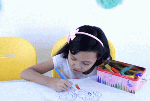 the child is drawing soing at the table