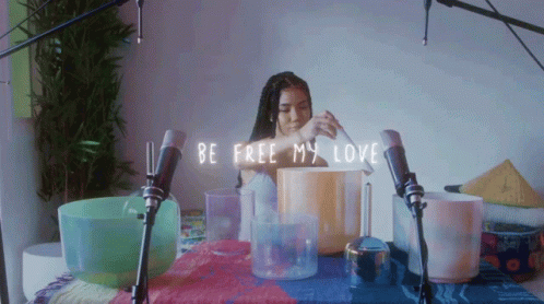 a pograph of a woman behind three candles that spell out be free my love