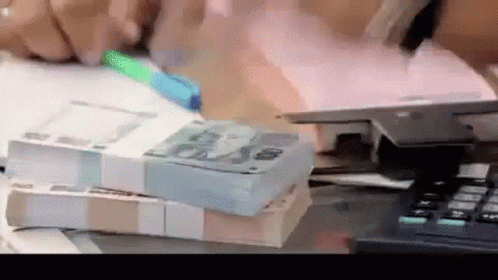 a stack of cash sitting on top of a table