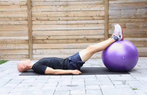 there is a man doing exercises on an exercise ball