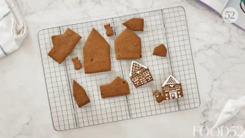several small house decorations are on a baking sheet
