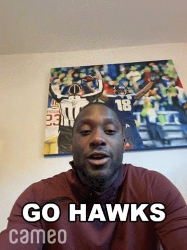 a man with a funny caption saying go hawks
