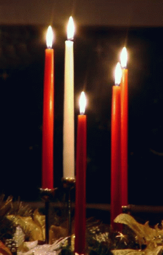three candles lit up on the inside of an empty room