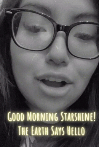 a  wearing glasses with the words'good morning star shines'written on her face